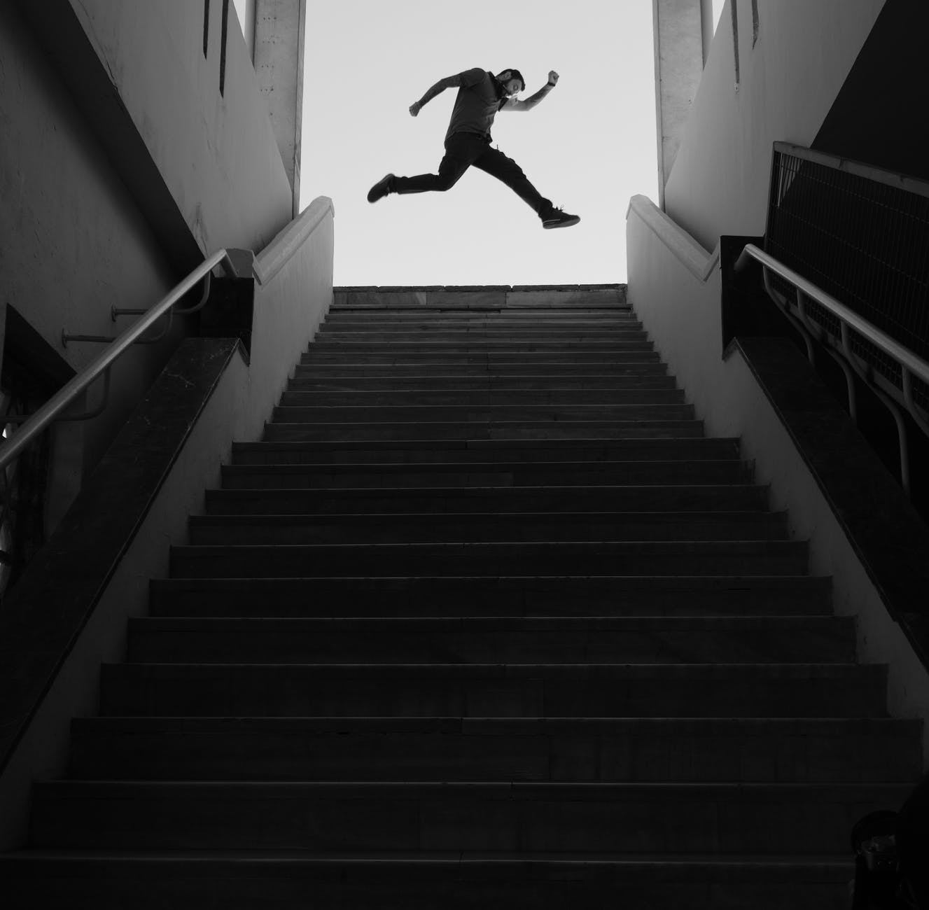 man jumping on top of a stairs