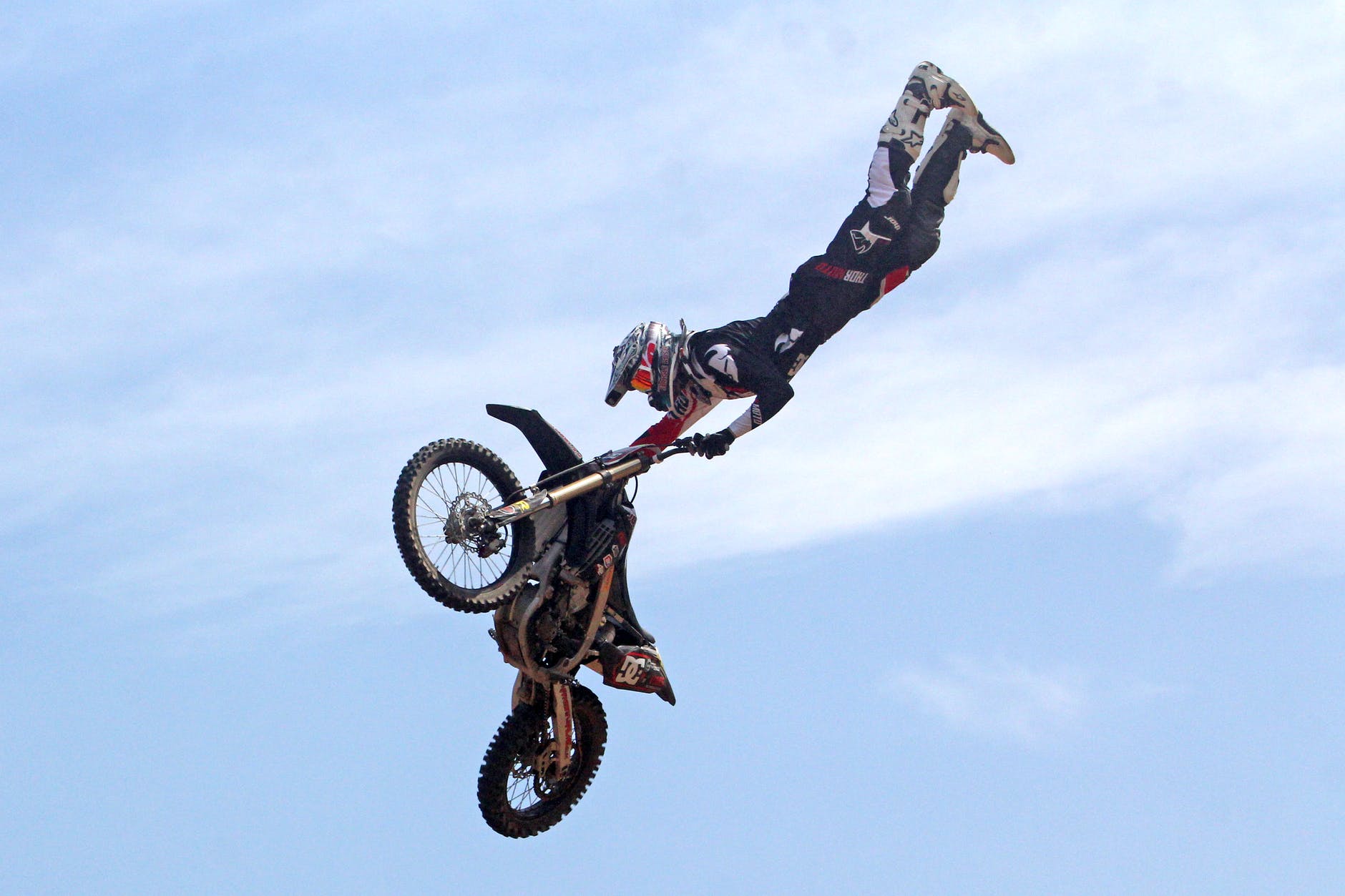 person holding motorcycle under blue sky