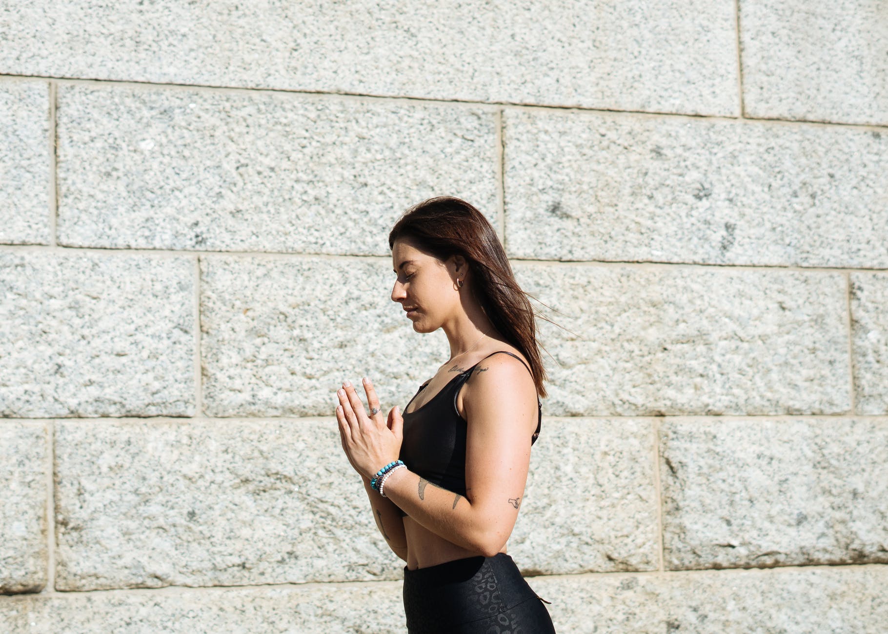 woman standing near concrete wall